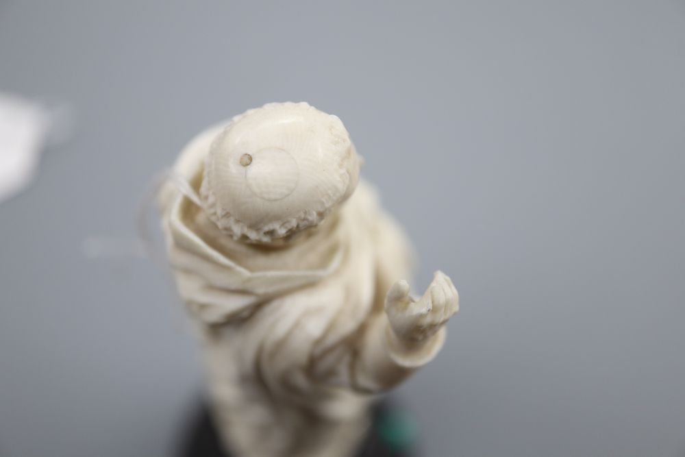 An ivory depiction of the Pope on wooden base, height 17cm